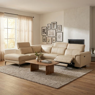 Beige sectional sofa in a living room with wooden coffee table and framed pictures on the wall.