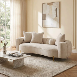 Beige sofa in a living room with abstract art on the wall