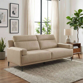 Beige sofa in a living room with plants and a window