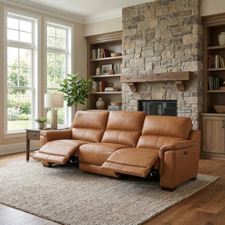 Brown leather sectional sofa in a living room with stone fireplace and bookshelves.