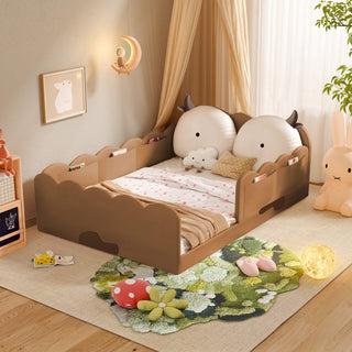 Children's room with a bed featuring animal-shaped headboards and decorative elements.
