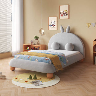 Children's room with a bed featuring cartoon character ears and colorful bedding.