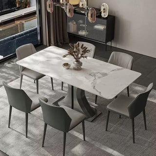 Dining room with a sintered stone table and modern chairs in a stylish interior.