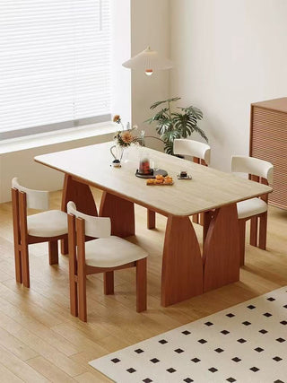 Dining room with a wooden table and chairs in a well-lit room.