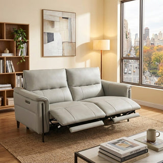 Gray sofa in a living room with a cityscape view through a window.