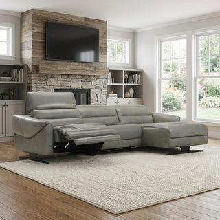 grey sectional sofa in a living room with a stone fireplace and large windows.