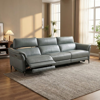 grey sectional sofa in a living room with wooden floor and large windows.