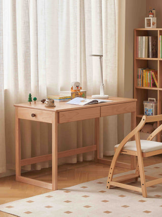kids Wooden desk with chair in a room with curtains and a bookshelf.