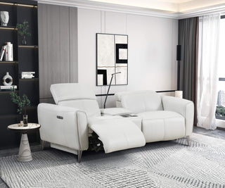 Modern electric recliner sofa in white color with side buttons and built-in USB ports, positioned in a room with a minimalist design aesthetic.