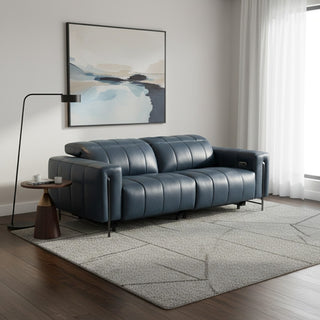 Modern living room with a blue leather sofa, abstract art, and a floor lamp.