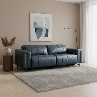 Modern living room with a blue sofa, abstract art, and decorative elements.
