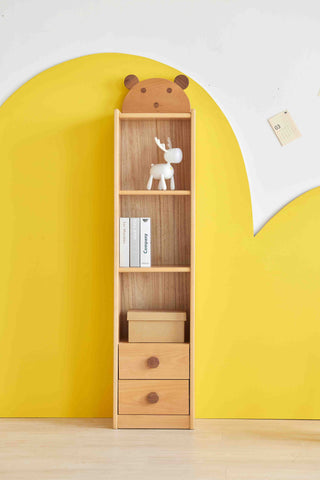 Wooden bookshelf with decorative items against a yellow wall