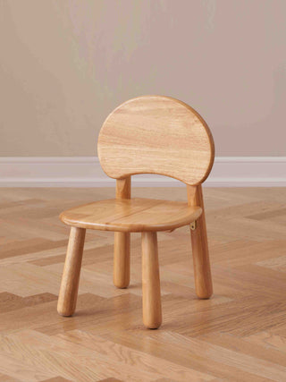 Wooden chair on a wooden floor with a beige wall background