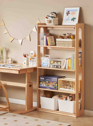 Wooden children's desk and bookshelf with toys and books in a room.