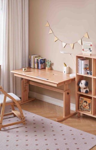 Wooden desk in a room with a bookshelf and decorative items.
