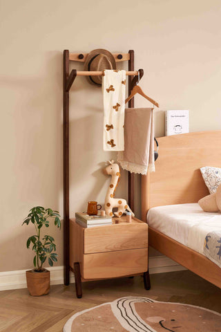 Wooden headboard with towel rack, plant, and toys in a bedroom setting.